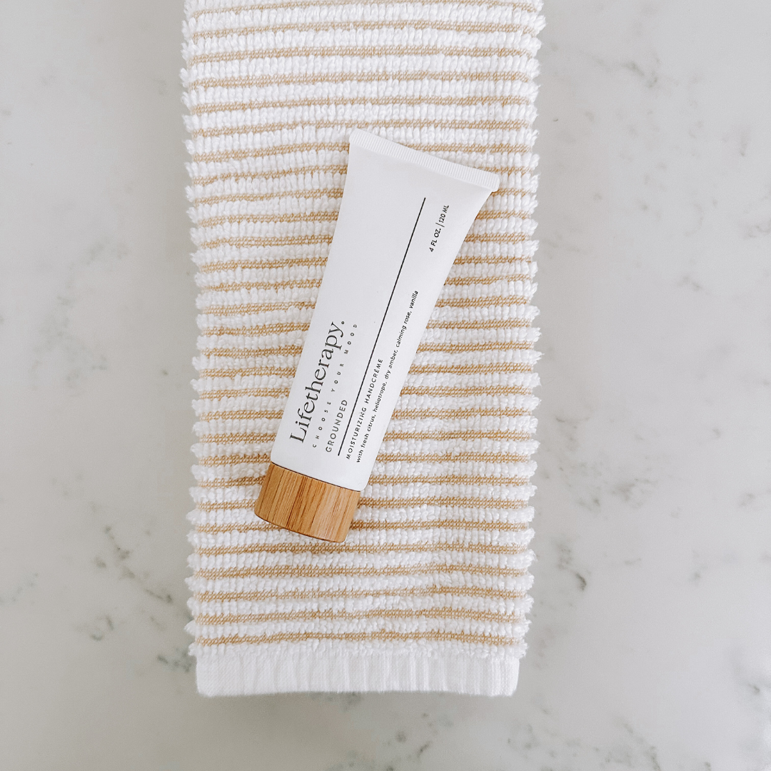 Grounded Lifetherapy hand cream for dry skin with calming amber and fresh citrus essential oils.