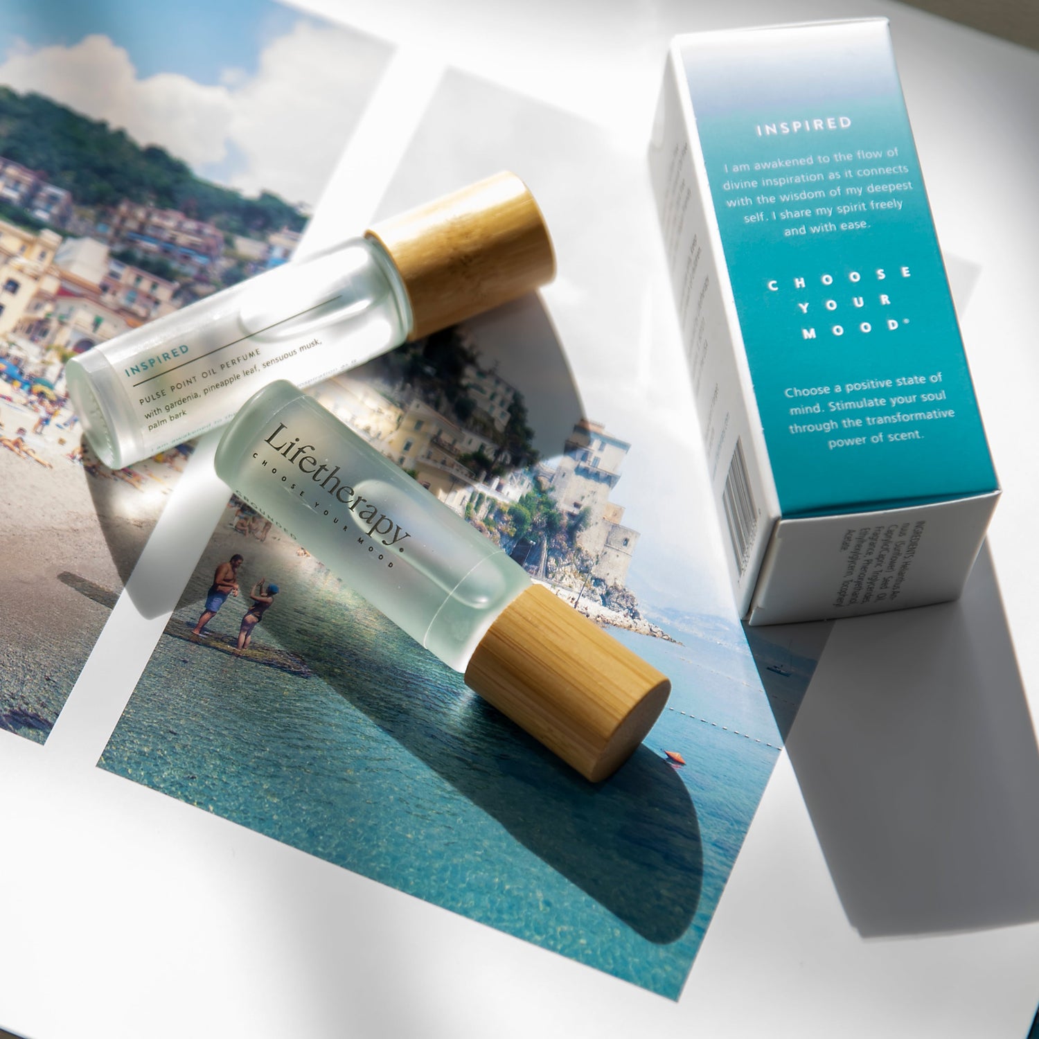 Inspired Lifetherapy fragrance oil glass rollerball with bamboo cap featuring gardenia and white musk. With soft touch box